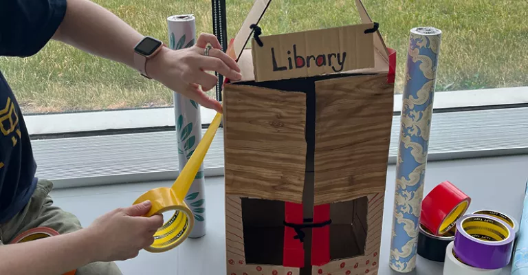 Creating crafts with cardboard and tape.