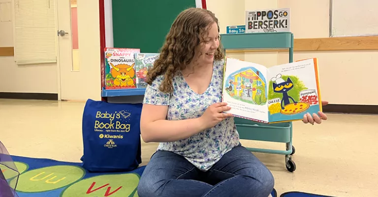 Woman holding a picture book.