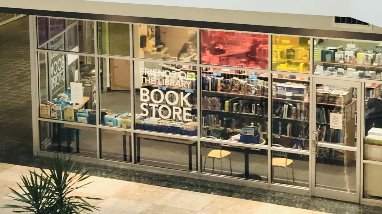 A photo of the Friends Book Store looking in from Citi Plaza with book shelves in the background