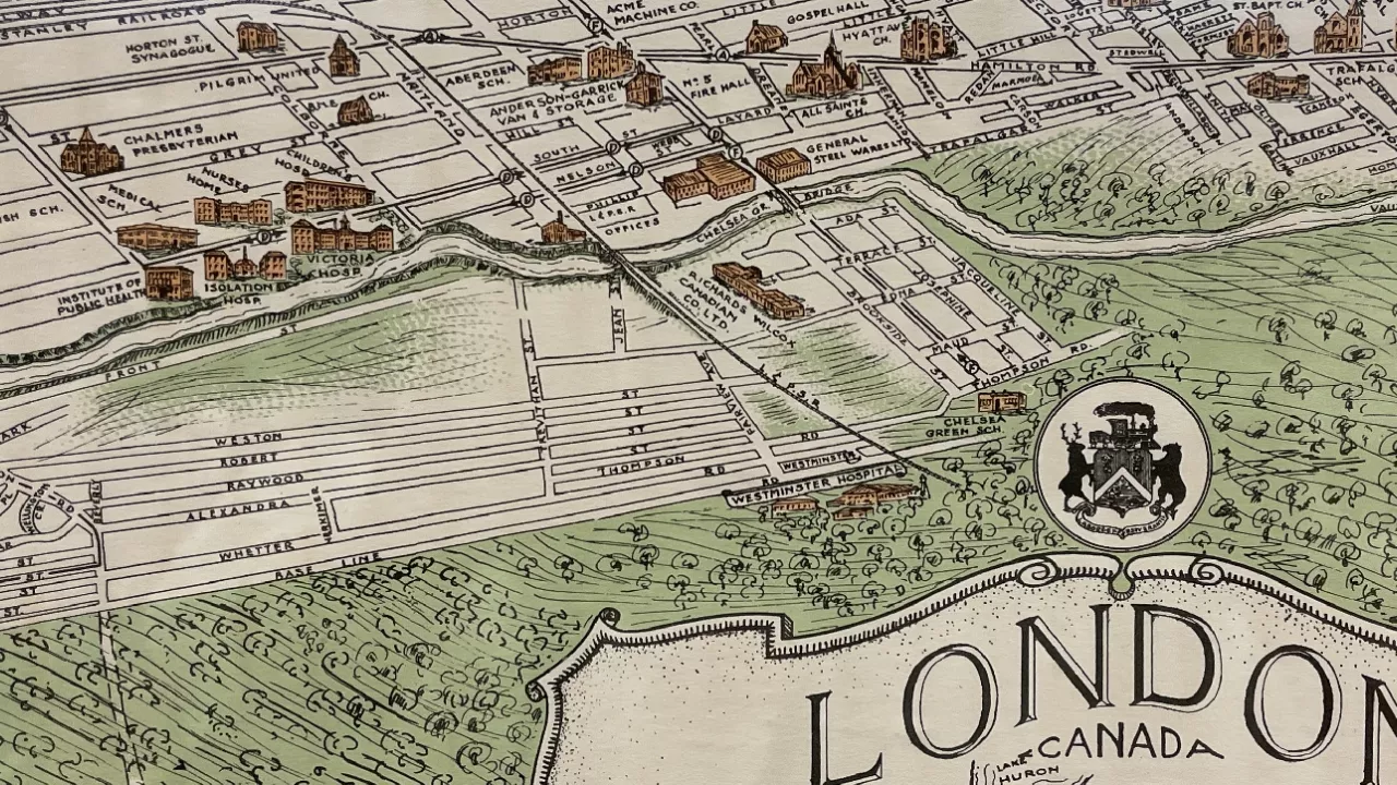 Photo of a section of an old city of London map showing streets and houses in brown and green on white.