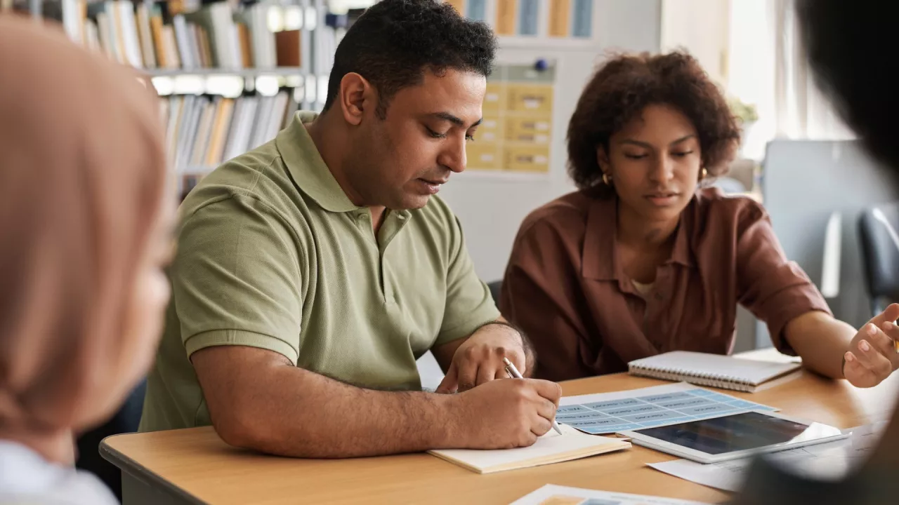 2 people at a study table learning together
