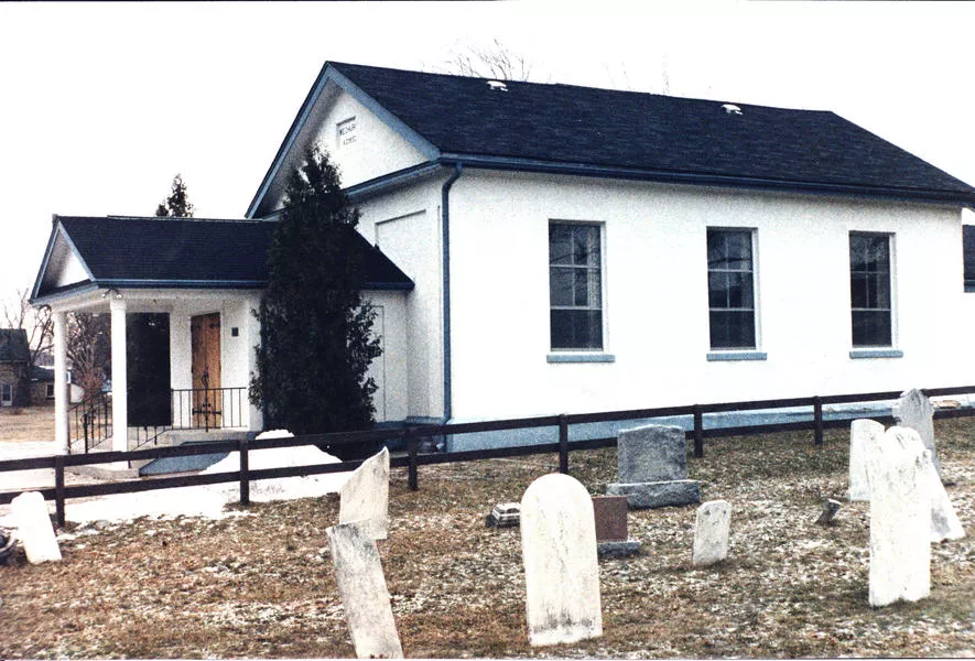 brick street methodist church with headstones in the foreground