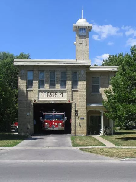 Colour photograph of the fire station and red fire truck. Looking Westward