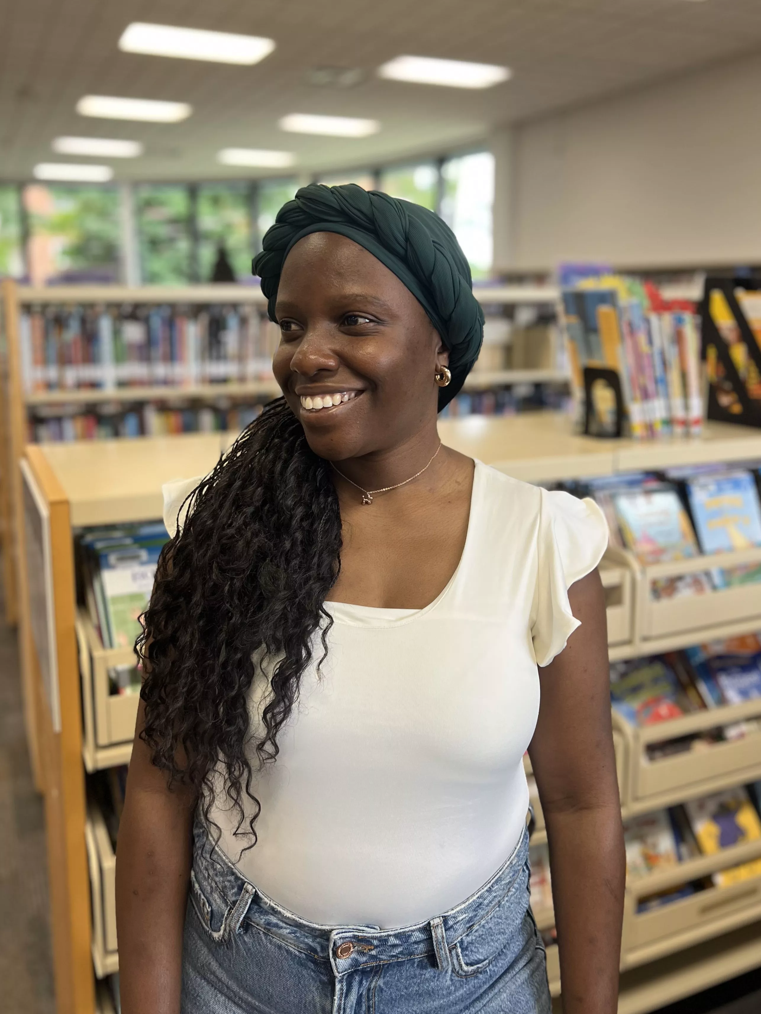 Taffy Maposa smiling at the library.