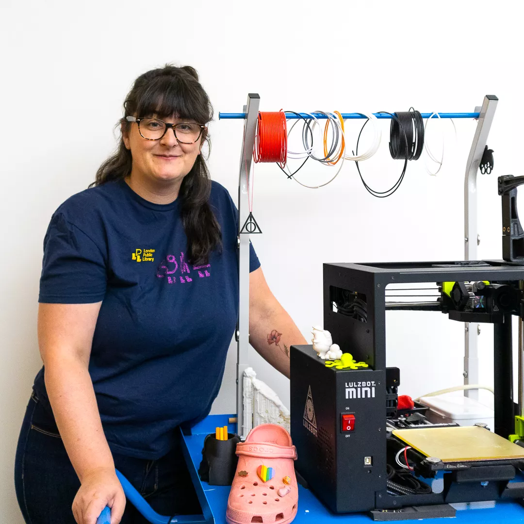 A staff member standing beside our 3d printer