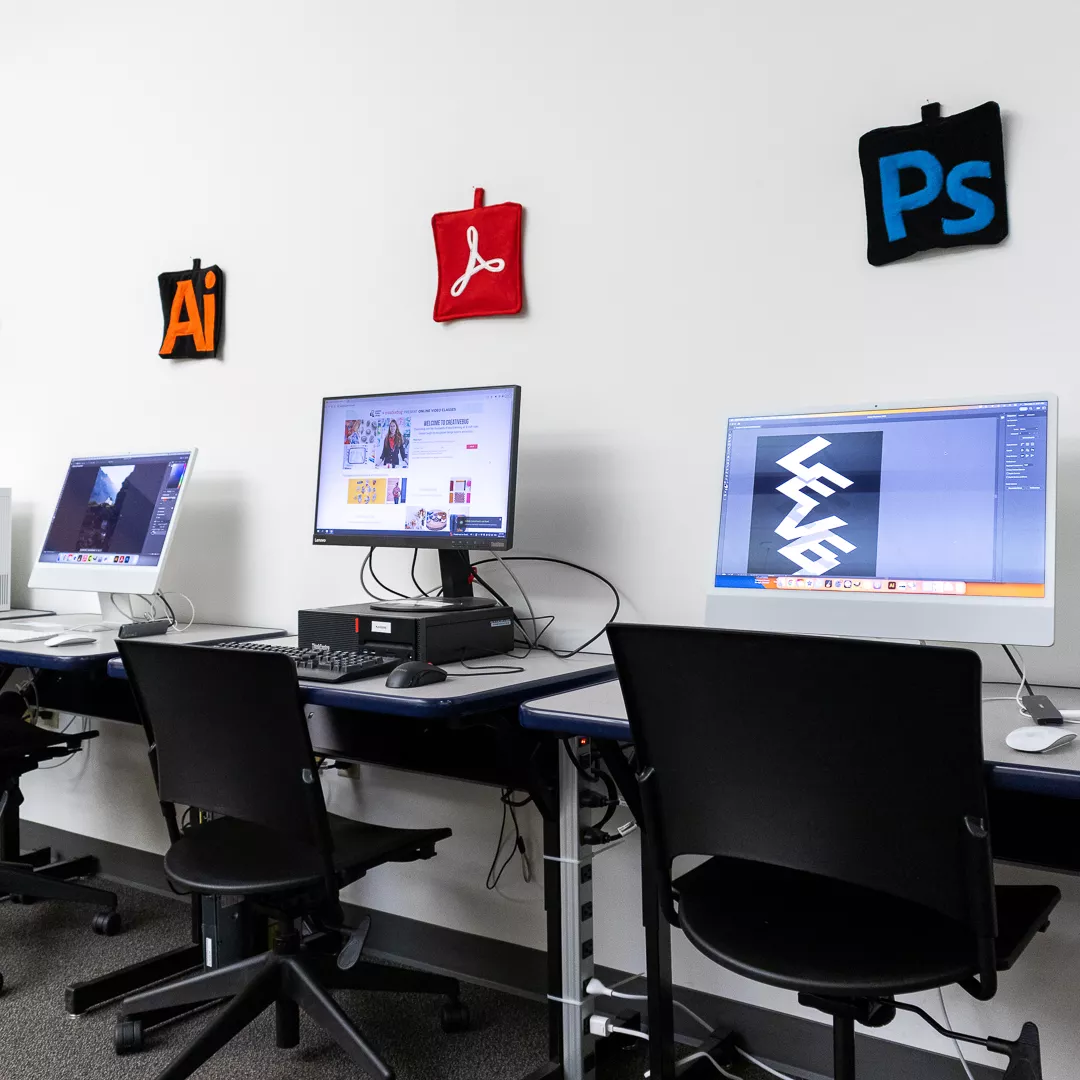 A group of computers with Adobe software in the Labs