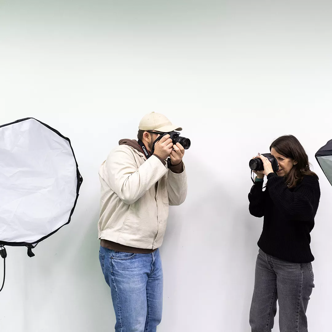 Two people using cameras to take photos in Media Lab