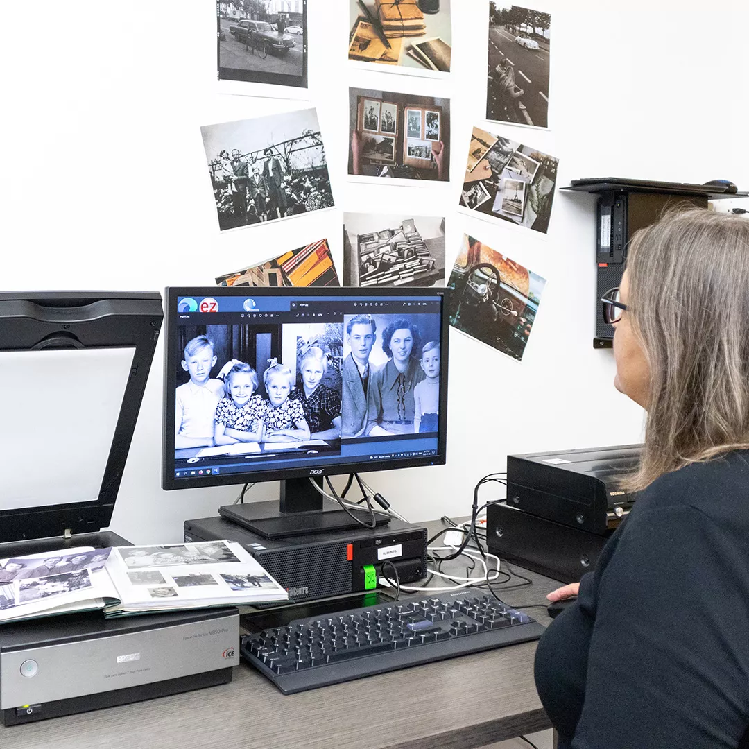 A patron looking at digital version of their photos on a computer