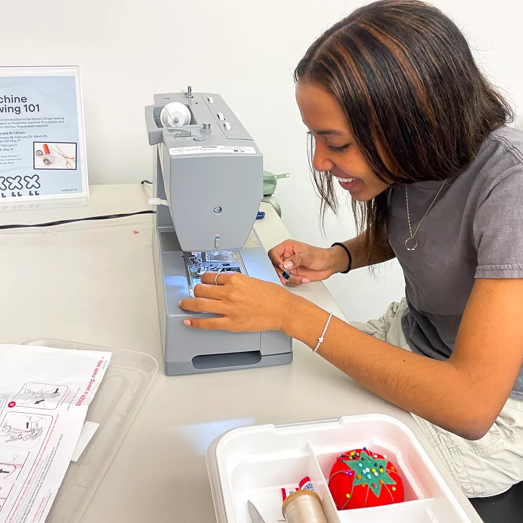 a girl using a sewing machine